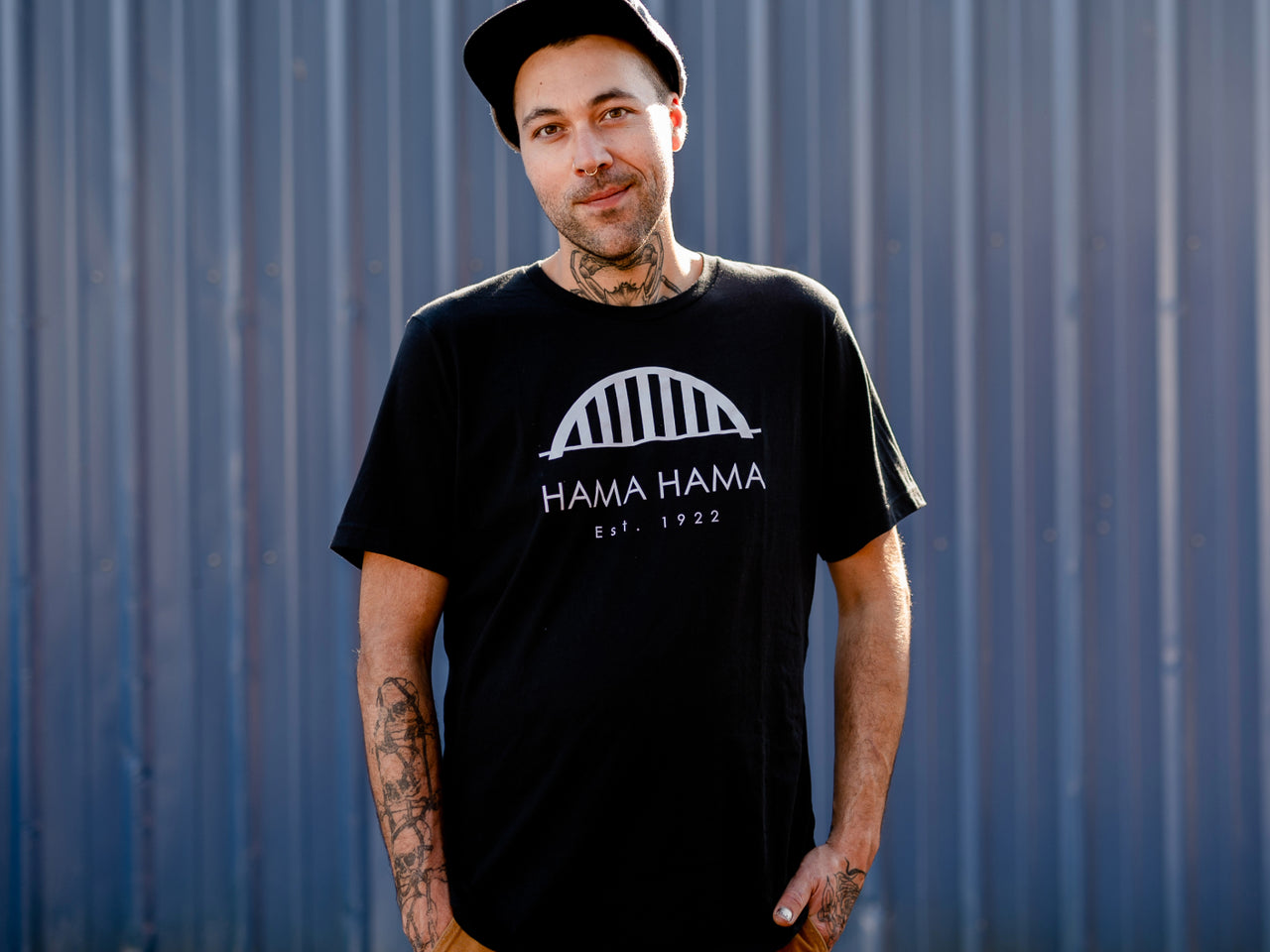 person modeling the black Hama Hama Oyster Company bridge logo tee shirt 