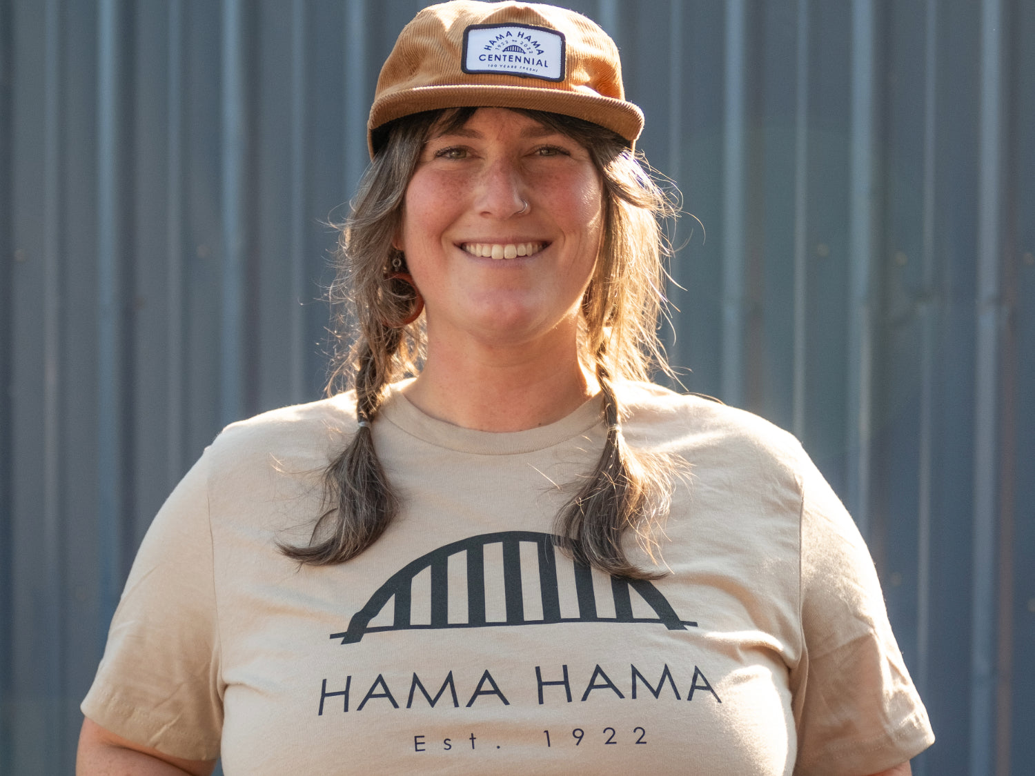 a person modeling the tan Hama Hama Oyster Company bridge logo tee shirt 
